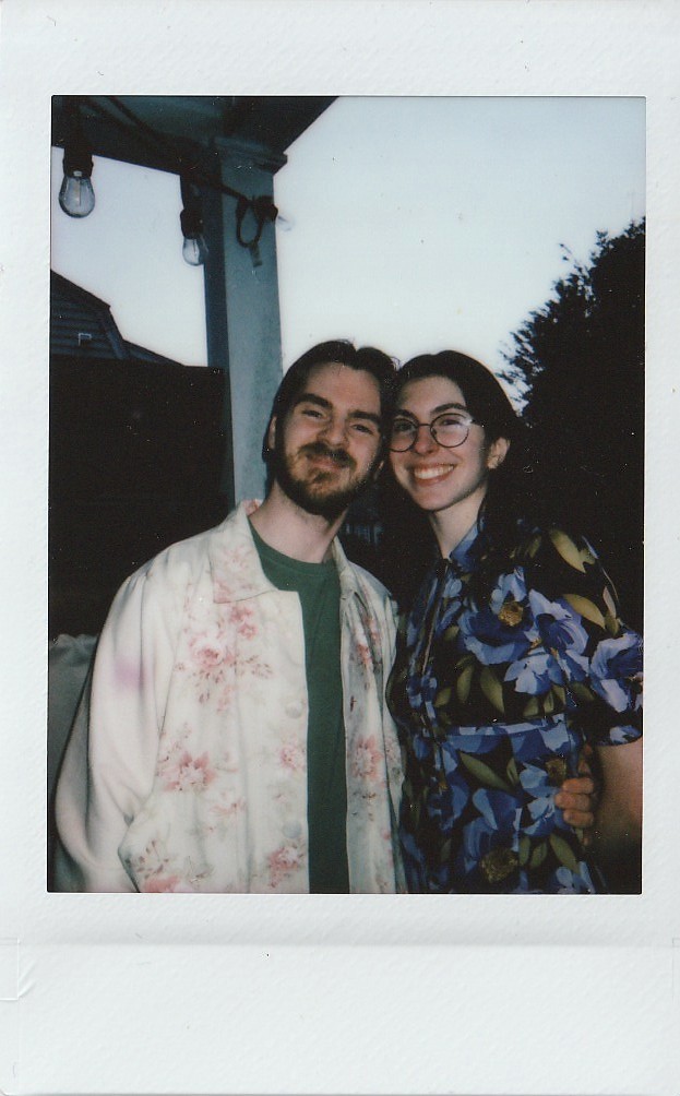 A polaroid of Jen and Morgan smiling on the porch.